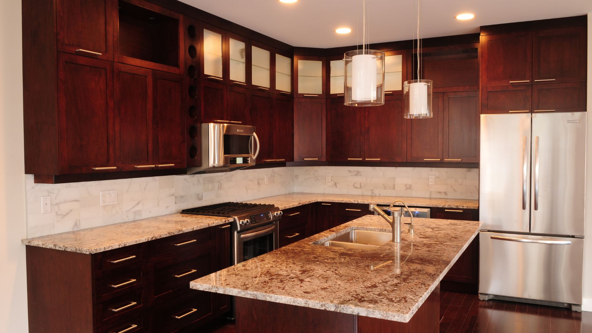 A kitchen with marble counter tops and wooden cabinets