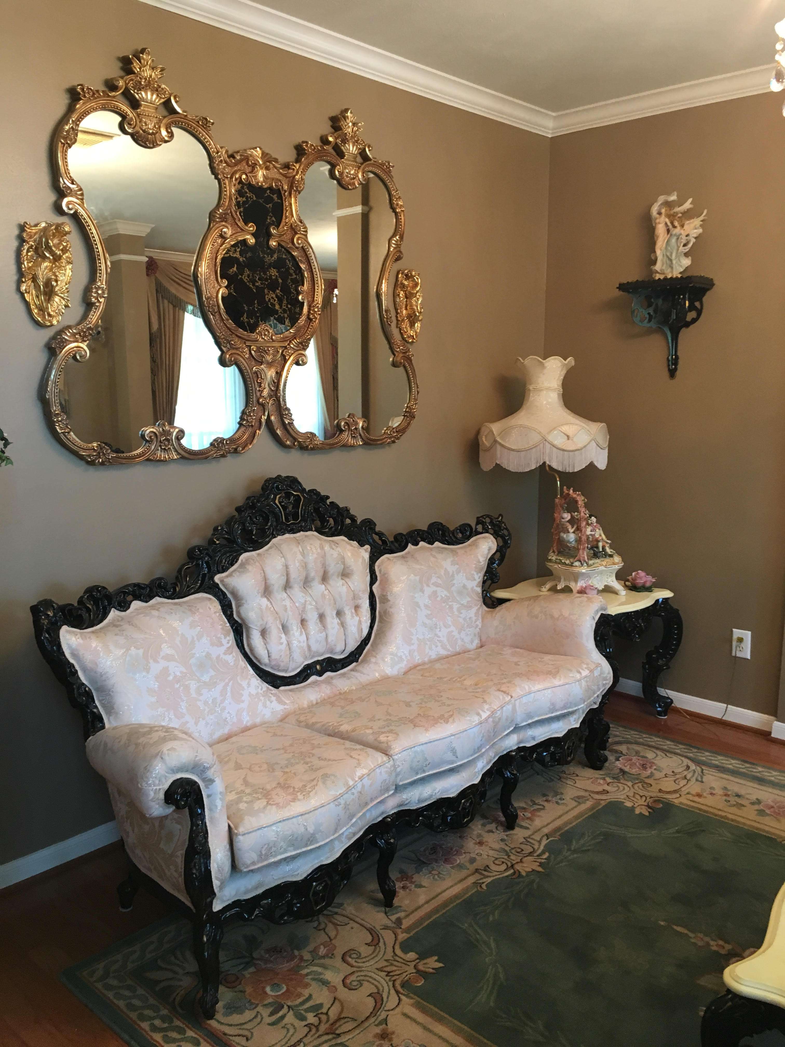 A living room filled with furniture and mirrors